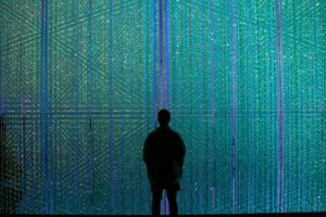 a person standing in front of a wall of lights